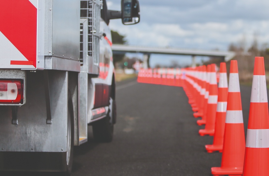 [image] road cones next to a traffic management vehicle 