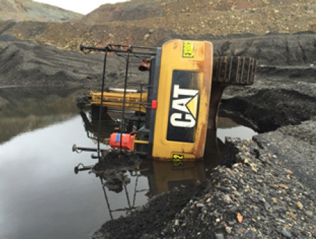 [image] Excavator tipped over sideways in a pond