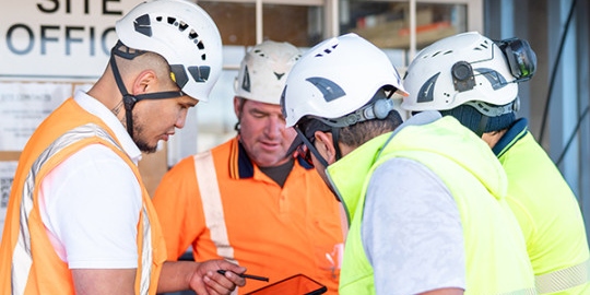 wide construction workers with tablet